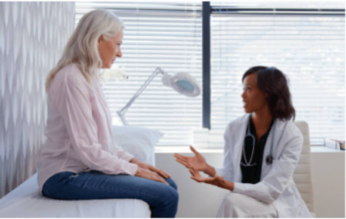 a woman talking to a doctor about her symptoms (actor portrayal)